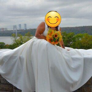 Satin ivory Ballgown with a low cut and side pockets